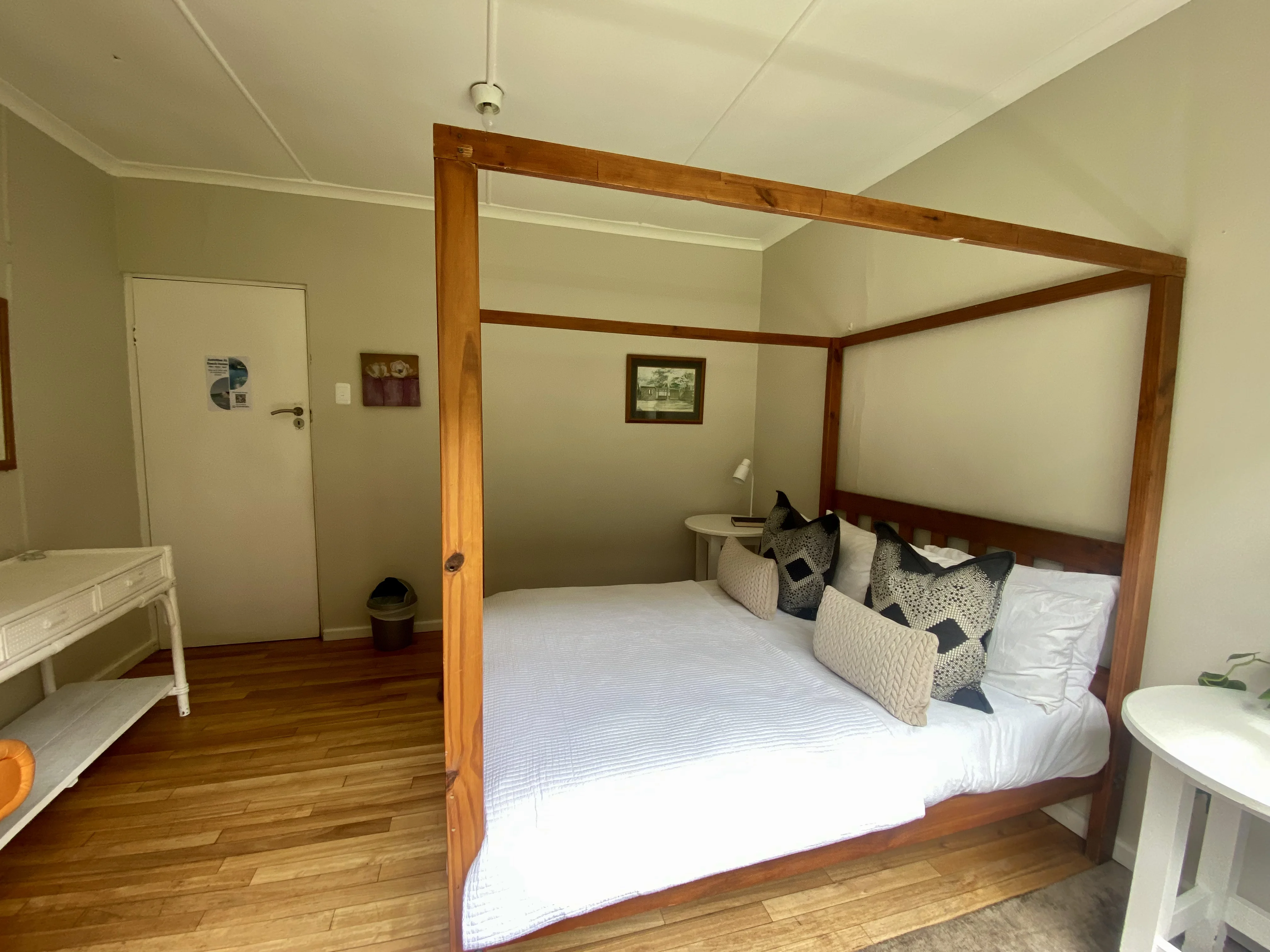 Private room with four-poster bed at Beach House Backpackers