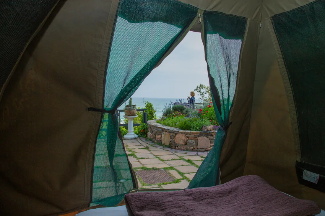 Looking out from a garden tent at Beach House towards the garden and the Indian Ocean