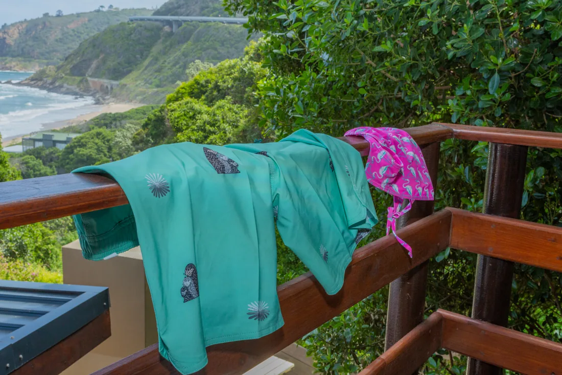 Swimwear drying on a balcony rail at Beach House, looking along Wilderness Beach